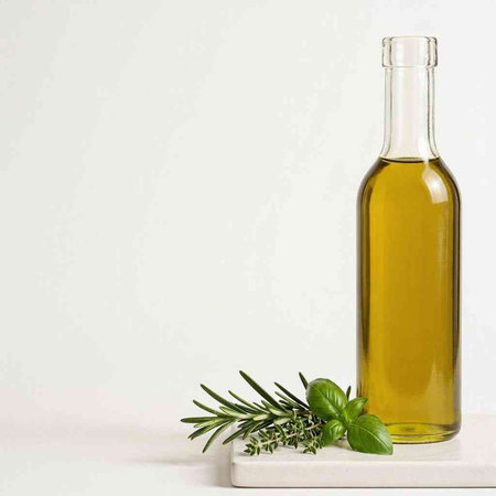 Olive oil bottle with rosemary twig on white background.
