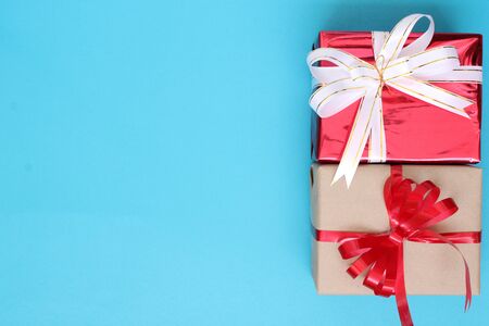 Red and brown gift box on blue paper on Christmas conceptの写真素材