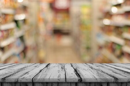 Empty gray wood tables and shelves, blurred background