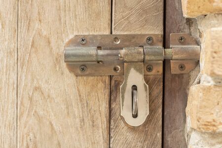 Old door bolts on wooden doorsの写真素材