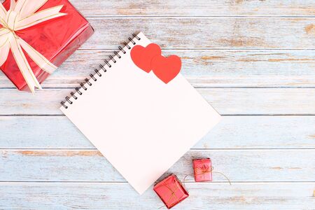 Heart with a gift box and a book on a wooden floor. Valentine concept - imageの写真素材