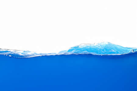 The surface of the blue water that moves and splashesの写真素材