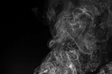 Abstract white smoke animated on a black backgroundの写真素材