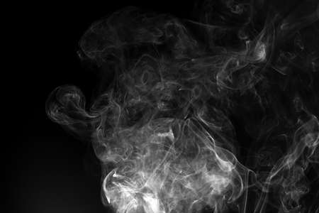 Abstract white smoke animated on a black backgroundの写真素材