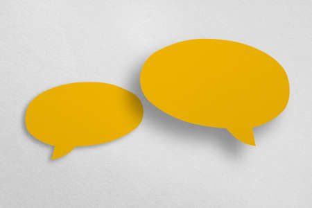 Speech balloon shaped yellow paper isolated on white background Communication bubbles.の写真素材