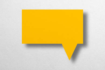 Speech balloon shaped yellow paper isolated on white background Communication bubbles.の写真素材