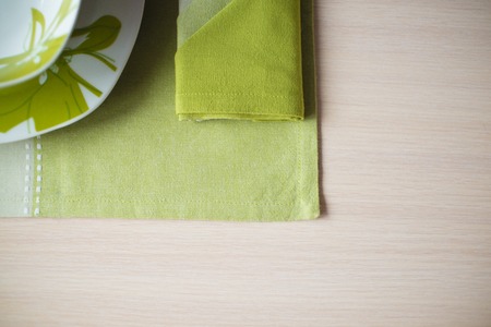 plates,a green tablecloth on the Wooden tableの写真素材