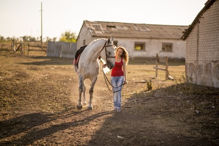 she leads the horse by the bridleの写真素材