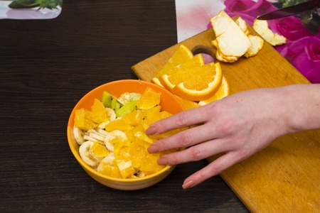cut bananas and kiwi on a wooden boardの写真素材