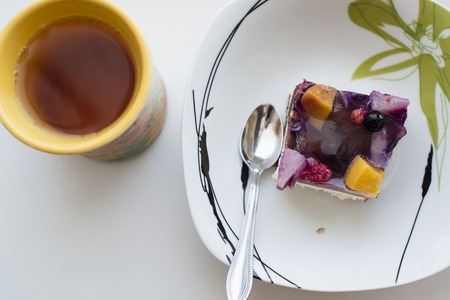 fruit cake and tea on a white table