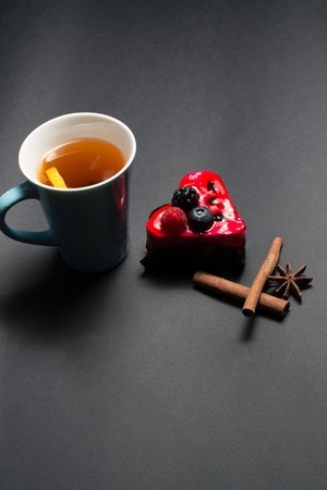 Cup of Tea, Cake cinnamon, star anise Cake in the shape of heartの写真素材