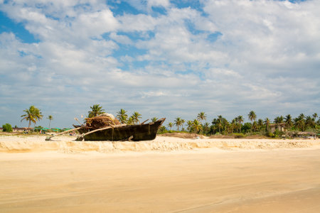 Wooden fishing boat on sandy shore standsの写真素材