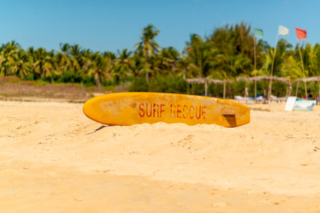 Lifeguard surfboard on a sandy shoreの写真素材