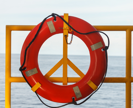 Safety equipment, Life buoy or rescue buoy stand by sea to rescue people from drowning man in sea off shore.の写真素材