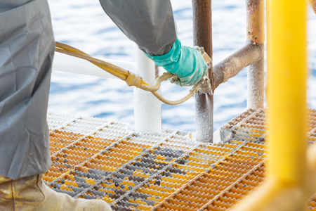 Painted rust,corrosion with Spray Gun on production platform ,Energy and petroleum industry sea offshoreの写真素材
