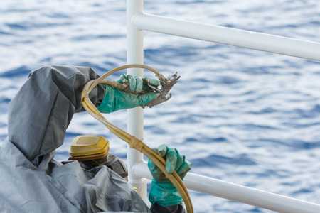 Painted rust,corrosion with Spray Gun on production platform ,Energy and petroleum industry sea offshoreの写真素材