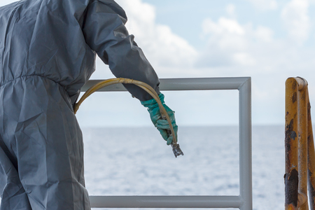Painted rust,corrosion with Spray Gun on production platform ,Energy and petroleum industry sea offshoreの写真素材