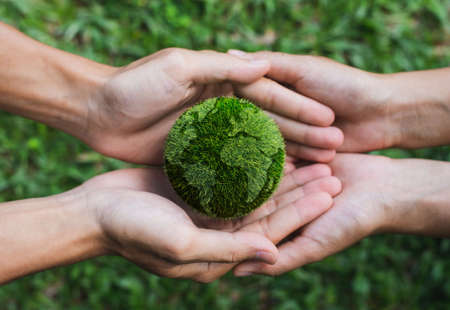 Earth Day. Hands adult Teamwork harmony Holding earth on hands. Environmental and reduce global warming help earth, top view. ecology and environment sustainable concept.の写真素材