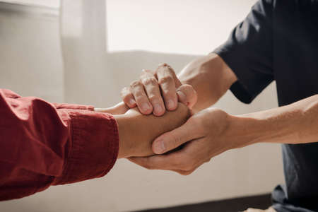 Christian couple holding hands. Two people are praying together. pray together, Hands folded in prayer concept for faithの写真素材
