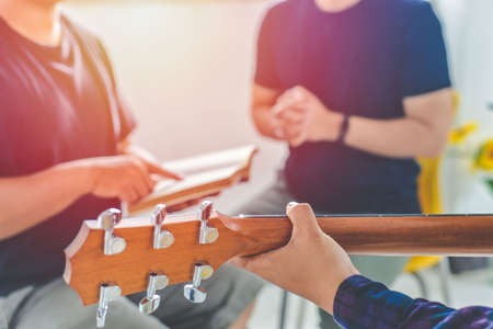 Christian family worship God in home, with a guitar and the Holy Bible. praise and worship conceptの写真素材