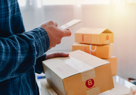 Closeup view of man online store small business owner seller entrepreneur packing package post...
