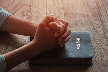 Woman prayer on bible, worship and religion. concept for faith, old Bible. copy spaceの写真素材
