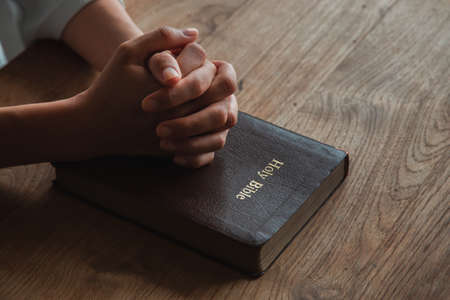 Woman prayer on bible, worship and religion. concept for faith, old Bible. copy space
