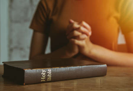 Woman prayer on bible, worship and religion. concept for faith, old Bible. copy spaceの写真素材