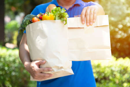 Food service providers wear masks. Stay at home reduce the spread of the covid-19 virus.の写真素材