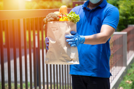 Food service providers wear masks. Stay at home reduce the spread of the covid-19 virus.の写真素材