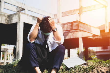 Asian businessman professional failed or upset with hand on head. Image of Stressed businessman concept.の写真素材