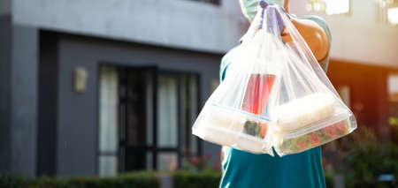 Food service providers wear masks. Stay at home reduce the spread of the covid-19 virus.の写真素材