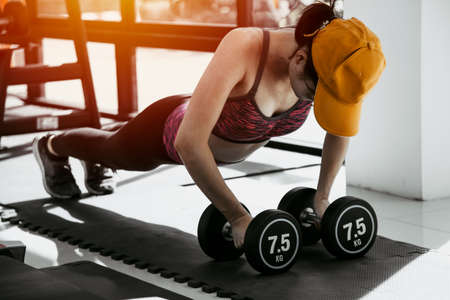 Fitness woman in training. Strong abs showing in the morning. At the gymの写真素材