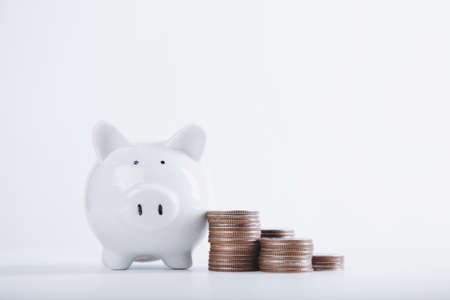 Piggy bank saving with money stack coin white background. Finance Savings conceptの写真素材