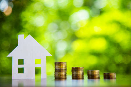 Coins and paper home for money saving financial, Business financial and saving money concept.の写真素材