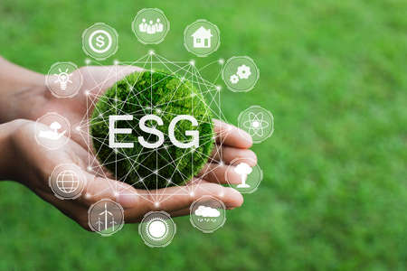 Hands holding the green ball that writes the word ESG with ESG icon concept for environmental....