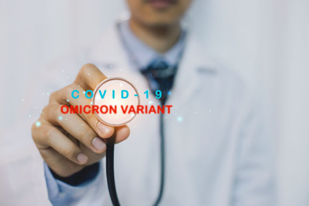 Medicine doctor and stethoscope in hand Omicron variant of SARS-CoV-2. New B.1.1.529 Variant of concern. Doctor holds vaccine against new covid-19 omicron variant. New generation vaccine against.の写真素材