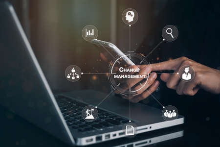 Businesswoman using phone in office document Change management in organization and business concept with consultant presenting icons of strategy. Organizational transition and transformationの写真素材