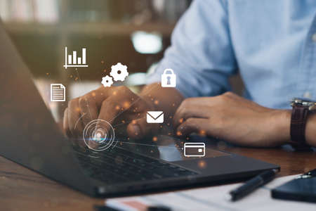 Businessman using a computer to AR virtual screen dashboard with project management with icons of scheduling, budgeting, communication.の写真素材