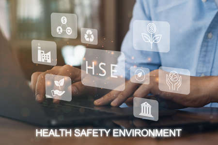 Businessman using a computer to HSE - Health Safety Environment acronym Banner web icon for business and organization. Standard Safe Industrial Work and industrial. Poster design.の写真素材