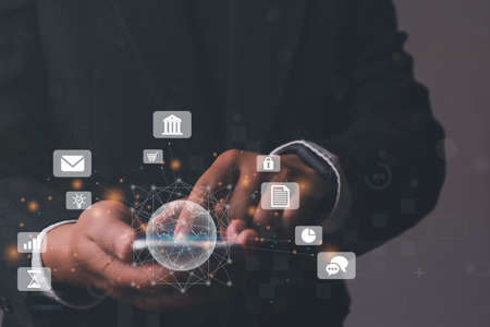 Businessman using mobile smart phone, IoT Internet of Things, Digital marketing media (website ad, email, social network, SEO, video, mobile app) E-commerce and online shopping conceptの写真素材
