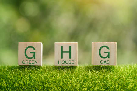 Business and GHG concept. Copy space. Greenhouse gas symbol. Concept words 'GHG, greenhouse gas' on cubes and blocks on a beautiful green background.の写真素材