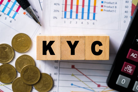 Business verifying the identity of its clients concept. KYC on wooden cubes. know your customer with magnifying glass.の写真素材