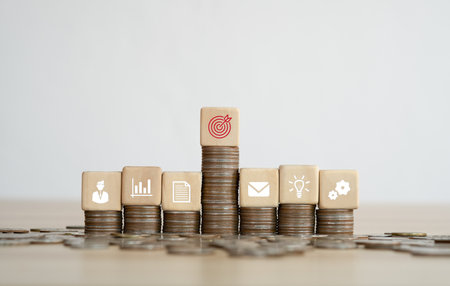 Wood cube block stacking on coins with icon. business strategy and action plan Concept. copy space.の写真素材