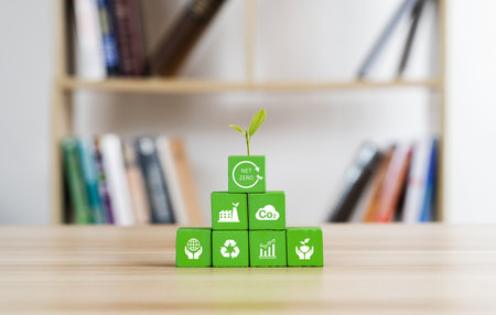 Carbon neutral and net zero concept natural environment Climate-neutral long-term strategy greenhouse gas emissions targets Wooden block with green net center iconの写真素材