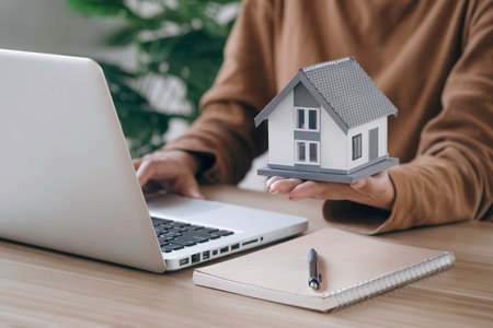 Female Real Estate Broker presenting and advised to model home and building project detail in the office, buying property concept. Tax, analysis for mortgage payment.の写真素材