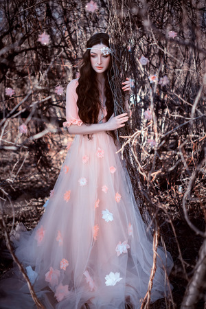 Women spring come after a long winter and awakens the nature of their presence, lady in a dress pastel, fashionable tining, creative computer colorsの写真素材