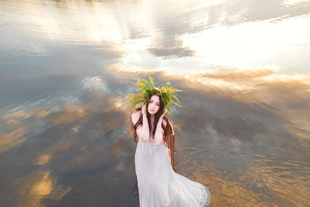 beautiful girl with a wreath on his head , sits on a rock near the fabulous Lake
fantastic shooting near water fairy image
fashion creative color toningの写真素材