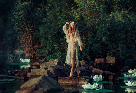 small -eared fairy standing surrounded by fantastic fairy lilies on the lake,
fantastic shot from the water , fairy-tale image
fashion creative color toningの写真素材