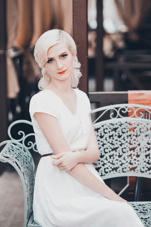 beautiful lady in the bright dress walking in the city , retro style , fashionable toning, creative colorの写真素材